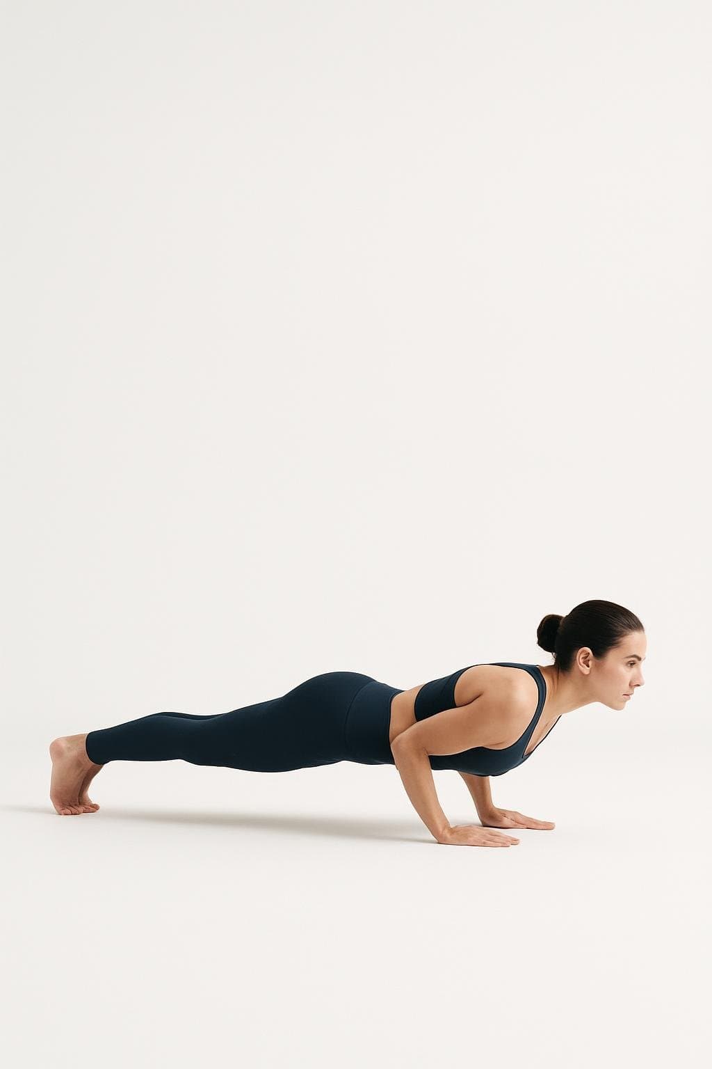 Four-Limbed Staff Pose (Chaturanga Dandasana) demonstrated